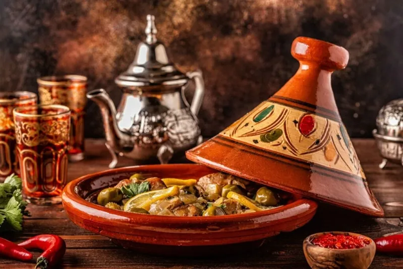 A vibrant display of Morocco Food Tour  featuring colorful vegetables and spices arranged on a rustic wooden table.