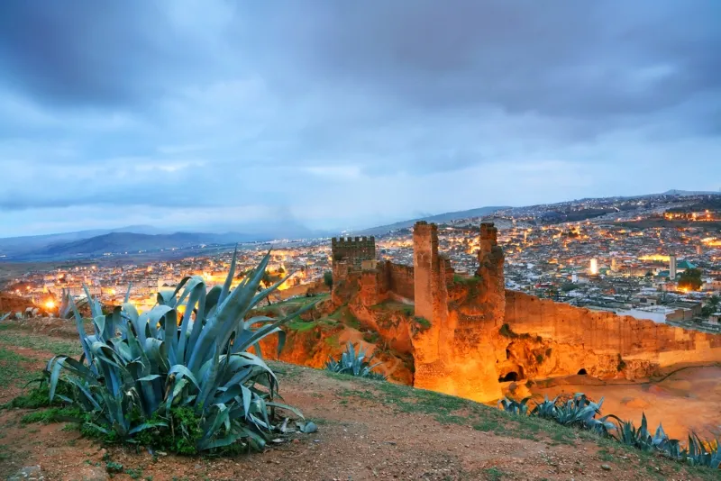Morocco at dusk, showcasing the city's skyline and vibrant colors, ideal for travel in spring or fall.