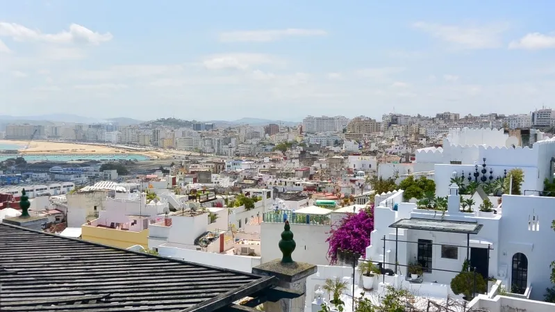 A panoramic view of the city skyline from a rooftop, with a hire car parked nearby in Morocco.