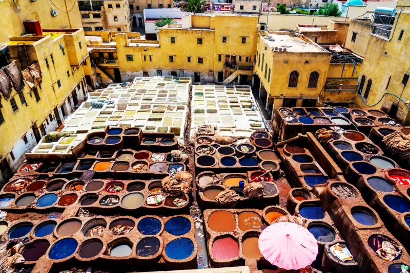 Colorful pots line the streets of Marrakech, showcasing the vibrant culture and artistry of Fes, Morocco.