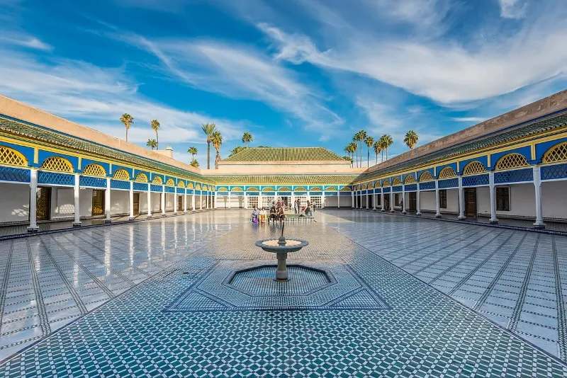 Courtyard of the Sultan's palace in Marrakech, showcasing intricate architecture and lush greenery, a key attraction in Morocco.